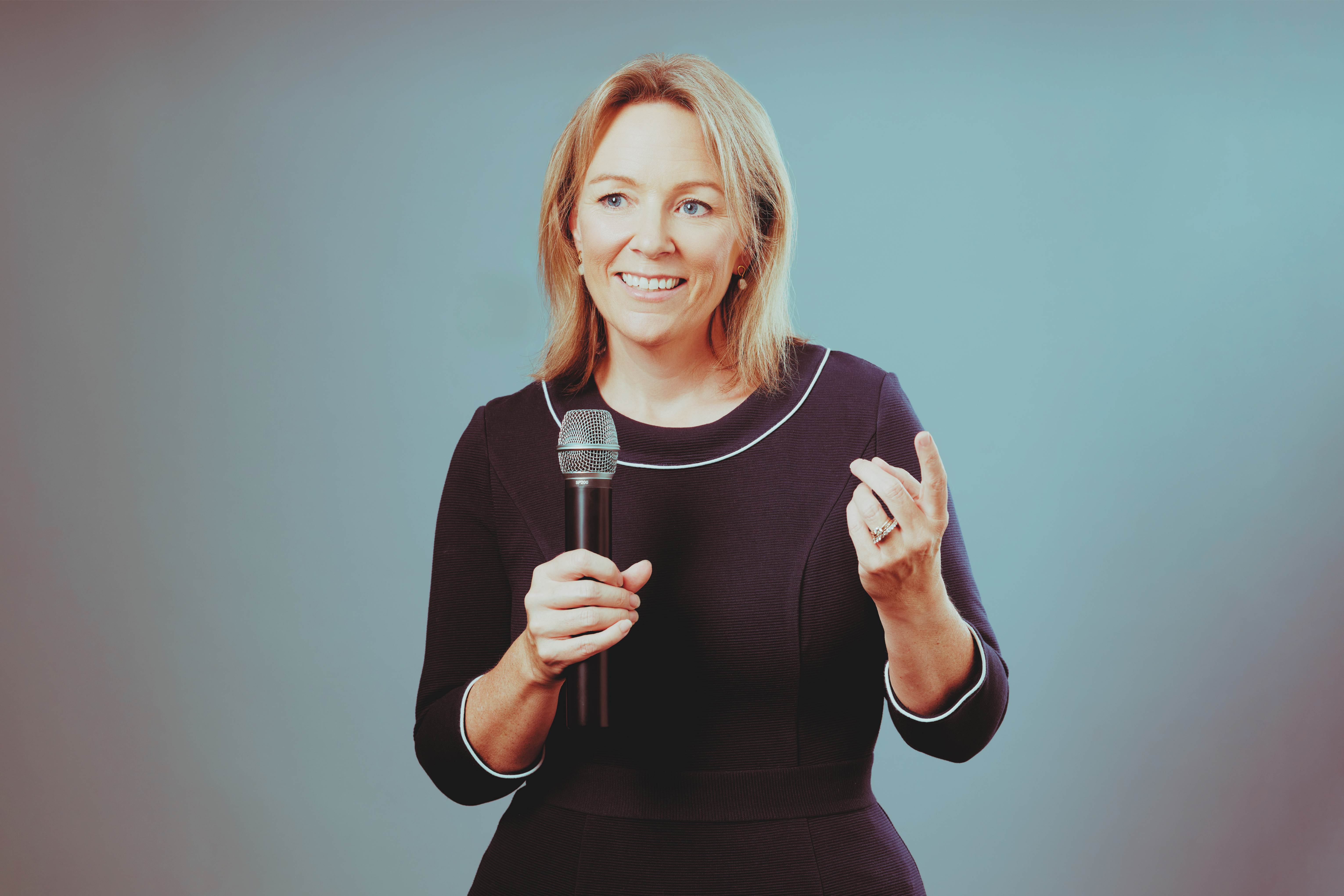 Holly Joint speaking into a microphone